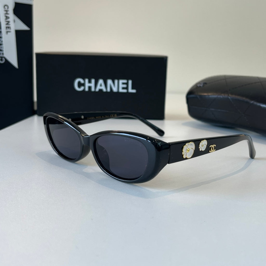 CHANEL Black Oval Sunglasses with Gold-Tone Accents