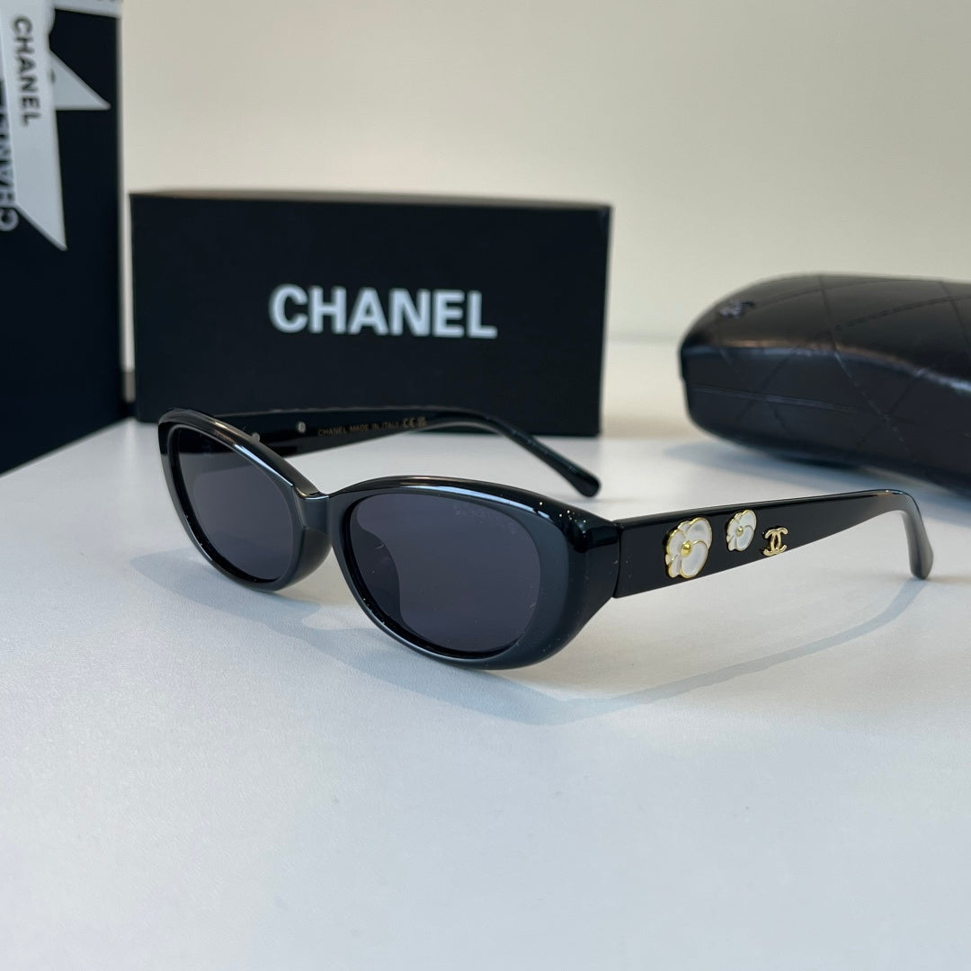 CHANEL Black Oval Sunglasses with Gold-Tone Accents