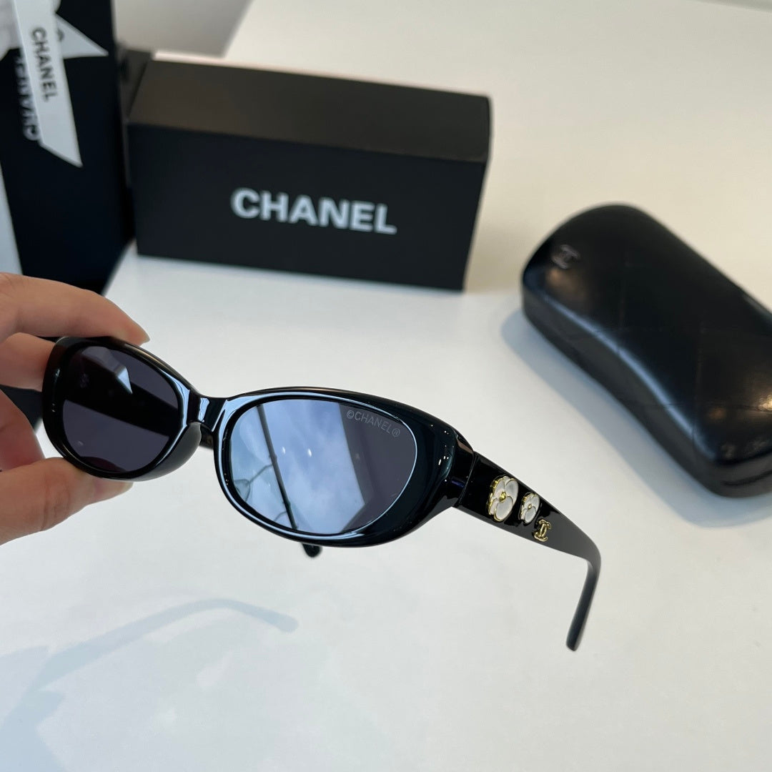 CHANEL Black Oval Sunglasses with Gold-Tone Accents