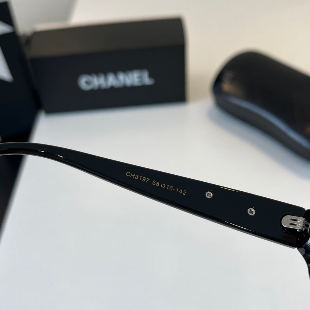 CHANEL Black Oval Sunglasses with Gold-Tone Accents