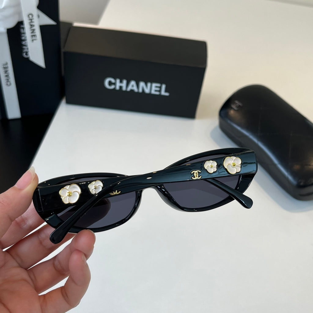 CHANEL Black Oval Sunglasses with Gold-Tone Accents