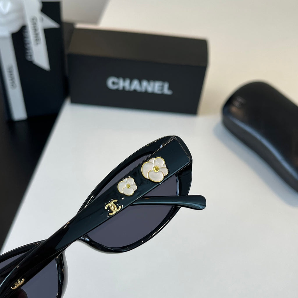 CHANEL Black Oval Sunglasses with Gold-Tone Accents