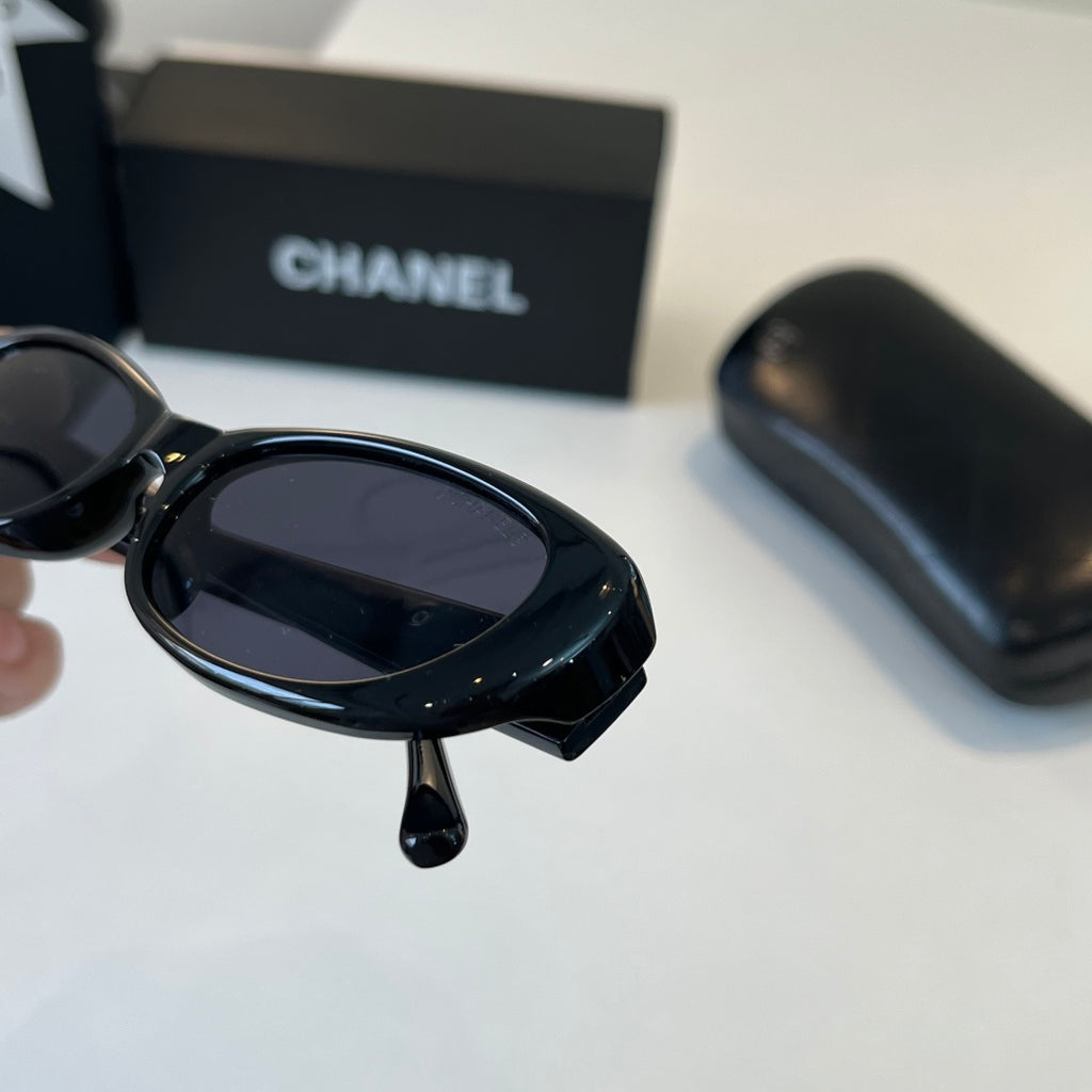 CHANEL Black Oval Sunglasses with Gold-Tone Accents